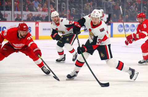 DETROIT, MICHIGAN – JANUARY 10: Rudolfs Balcers #38 of the Ottawa Senators takes a shot past the stick of Mike Green #25 of the Detroit Red Wings during the first period at Little Caesars Arena on January 10, 2020 in Detroit, Michigan. (Photo by Gregory Shamus/Getty Images)