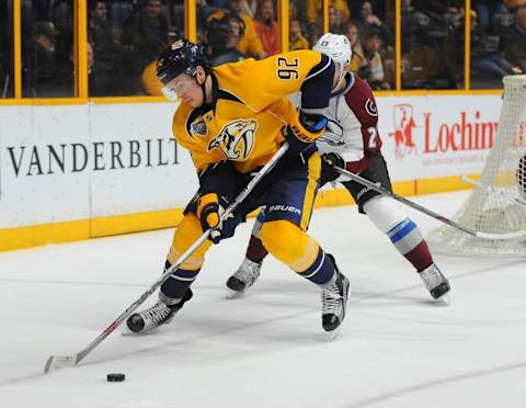 Mar 28, 2016; Nashville, TN, USA; Nashville Predators center Ryan Johansen (92) works against Colorado Avalanche center Mikhail Grigorenko (25) in the corner during the third period at Bridgestone Arena. Mandatory Credit: Christopher Hanewinckel-USA TODAY Sports