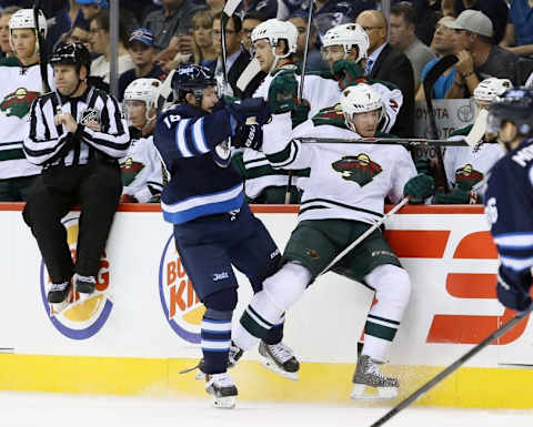 Winnipeg Jets forward Bryan Little (18) collides with Minnesota Wild defenseman Jonathon Blum (7). Mandatory Credit: Bruce Fedyck-USA TODAY Sports