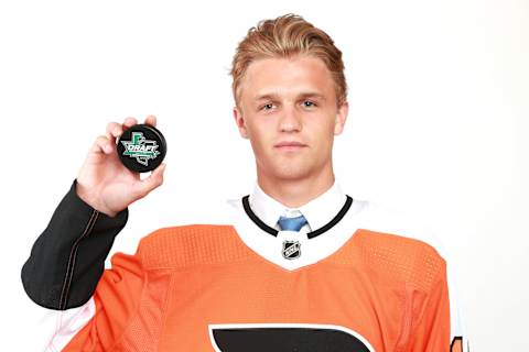 Adam Ginning poses after being selected 50th overall by the Philadelphia Flyers during the 2018 NHL Draft. (Photo by Tom Pennington/Getty Images)