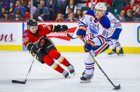 Sep 26, 2016; Calgary, Alberta, CAN; Edmonton Oilers defenseman Brandon Davidson (88) controls the puck as Calgary Flames left wing Dillon Dube (59) defends during a preseason hockey game at Scotiabank Saddledome. Mandatory Credit: Sergei Belski-USA TODAY Sports