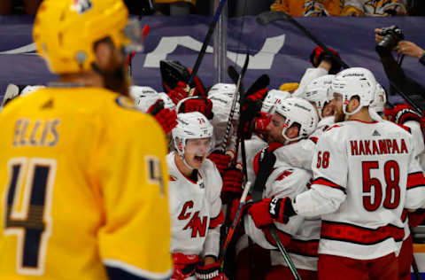 NASHVILLE, TENNESSEE – MAY 27: The Carolina Hurricanes celebrate after their 4-3 overtime victory against the Nashville Predators in Game Six of the First Round of the 2021 Stanley Cup Playoffs at Bridgestone Arena on May 27, 2021, in Nashville, Tennessee. (Photo by Frederick Breedon/Getty Images)