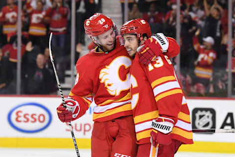 Oct 30, 2021; Calgary, Alberta, CAN; Calgary Flames forward Johnny Gaudreau (13) celebrates his third period goal with forward Elias Lindholm (28) against the Philadelphia Flyers at Scotiabank Saddledome. Flames won 4-0. Mandatory Credit: Candice Ward-USA TODAY Sports