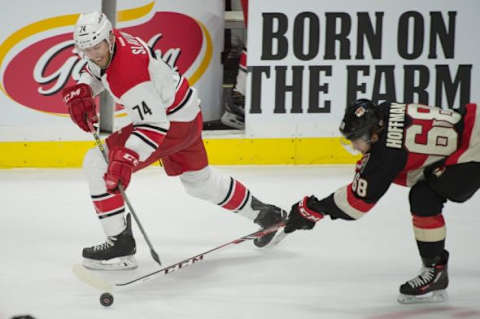 Feb 18, 2016; Ottawa, Ontario, CAN; Ottawa Senators left wing Mike Hoffman (68) steals the puck from Carolina Hurricanes defenseman Jaccob Slavin (74) in the third period at the Canadian Tire Centre. The Senators won 4-2. Mandatory Credit: Marc DesRosiers-USA TODAY Sports