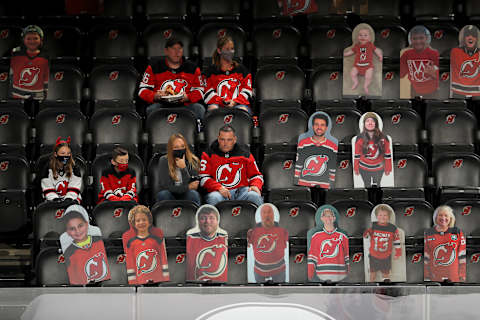 Fans watch as the New Jersey Devils warm up (Photo by Elsa/Getty Images)