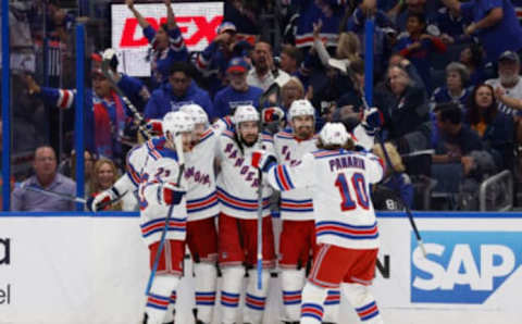 Jun 5, 2022; Tampa, Florida, USA; New York Rangers center Mika Zibanejad (93) celebrates with center Filip Chytil (72), left wing Artemi Panarin (10) and teammates as he scores a goal against the Tampa Bay Lightning during the second period of the Eastern Conference Final of the 2022 Stanley Cup Playoffs at Amalie Arena. Mandatory Credit: Kim Klement-USA TODAY Sports