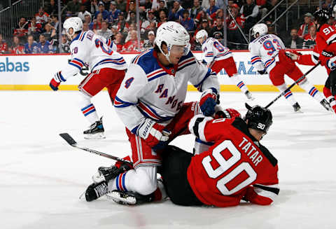 NEWARK, NEW JERSEY – APRIL 18: Braden Schneider #4 of the New York Rangers checks Tomas Tatar #90 of the New Jersey Devils during the second period of Game One in the First Round of the 2023 Stanley Cup Playoffs at the Prudential Center on April 18, 2023, in Newark, New Jersey. (Photo by Bruce Bennett/Getty Images)