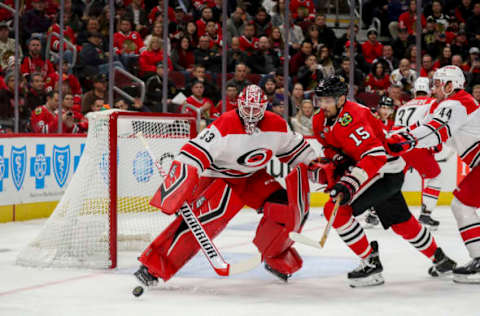 The Chicago Blackhawks’ Artem Anisimov (15) chases after the puck while Carolina Hurricanes goaltender Scott Darling (33) minds the net during the first period at the United Center in Chicago on Thursday, Nov. 8, 2018. The Canes won, 4-3. (Armando L. Sanchez/Chicago Tribune/TNS via Getty Images)