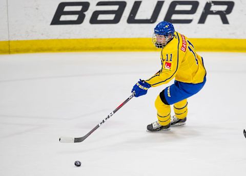 PLYMOUTH, MI – FEBRUARY 15: Oscar Back #11 of the Sweden Nationals turns up ice with the puck against the Finland Nationals during the 2018 Under-18 Five Nations Tournament game at USA Hockey Arena on February 15, 2018 in Plymouth, Michigan. Finland defeated Sweden 5-3. (Photo by Dave Reginek/Getty Images)*** Local Caption *** Oscar Back