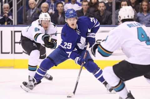 Dec 13, 2016; Toronto, Ontario, CAN; Toronto Maple Leafs center William Nylander (29) attacks with the puck as San Jose Sharks defenseman Justin Braun (61) hooks him at Air Canada Centre. Mandatory Credit: Tom Szczerbowski-USA TODAY Sports