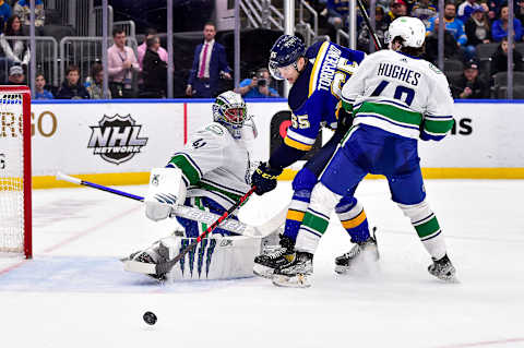 Mar 28, 2022; St. Louis, Missouri, USA; Vancouver Canucks goaltender Jaroslav Halak (41) and defenseman Quinn Hughes (43) defend against St. Louis Blues right wing Alexei Toropchenko (65) during the second period at Enterprise Center. Mandatory Credit: Jeff Curry-USA TODAY Sports