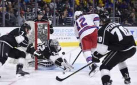 Mar 17, 2016; Los Angeles, CA, USA; Los Angeles Kings goalie Jonathan Quick (32) makes a save in front of New York Rangers center Eric Staal (12) during the third period at Staples Center. The Kings won in overtime 4-3. Mandatory Credit: Kelvin Kuo-USA TODAY Sports