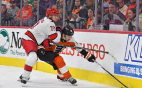 Oct 30, 2023; Philadelphia, Pennsylvania, USA; Carolina Hurricanes defenseman Tony DeAngelo (77) battles with Philadelphia Flyers right wing Bobby Brink (10) during the third period at Wells Fargo Center. Mandatory Credit: Eric Hartline-USA TODAY Sports