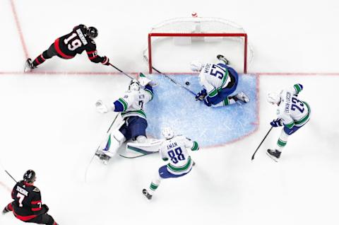 OTTAWA, CANADA – NOVEMBER 08: Drake Batherson #19 of the Ottawa Senators shot goes through Spencer Martin #30 of the Vancouver Canucks crease as his teammates Tyler Myers #57, Nils Aman #88 and Oliver Ekman-Larsson #23 look on in the third period of the game at Canadian Tire Centre on November 08, 2022 in Ottawa, Ontario, Canada. (Photo by Chris Tanouye/Freestyle Photography/Getty Images)