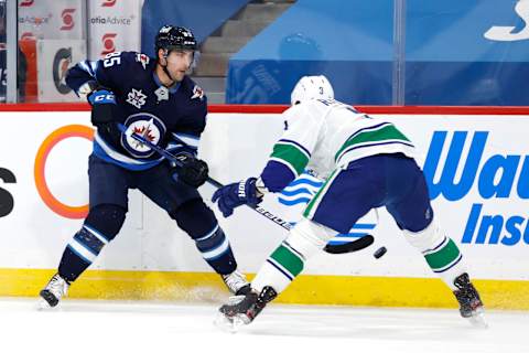 Winnipeg Jets, Mathieu Perreault (85); Vancouver Canucks, Jack Rathbone (3). Mandatory Credit: James Carey Lauder-USA TODAY Sports