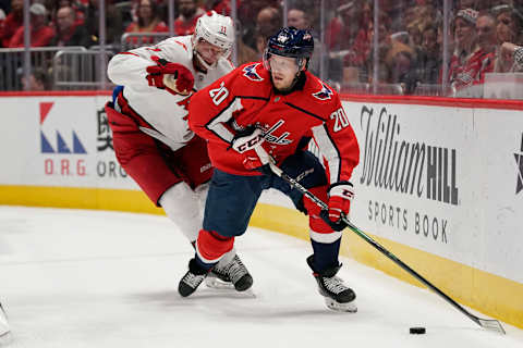 WASHINGTON, DC – JANUARY 13: Lars Eller #20 of the Washington Capitals skates with the puck against Jordan Staal #11 of the Carolina Hurricanes in the first period at Capital One Arena on January 13, 2020 in Washington, DC. (Photo by Patrick McDermott/NHLI via Getty Images)