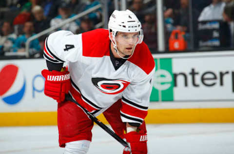 SAN JOSE, CA – MARCH 4: Andrej Sekera #4 of the Carolina Hurricanes in a faceoff against the San Jose Sharks at SAP Center on March 4, 2014 in San Jose, California. (Photo by Rocky Widner/Getty Images)