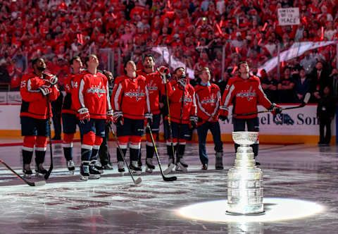 WASHINGTON, DC – OCTOBER 03: The Washington Capitals stand behind the Stanley Cup and watch the Championship Banner being raised on October 3, 2018, at the Capital One Arena in Washington, D.C. for the opening night game against the Boston Bruins. The Washington Capitals defeated the Boston Bruins, 7-0. (Photo by Mark Goldman/Icon Sportswire via Getty Images)