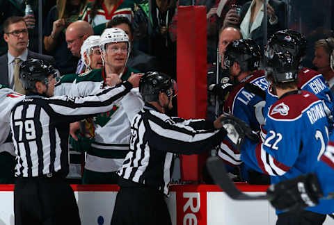 DENVER, CO – FEBRUARY 28: Linesmen Kiel Murchison #79 and Vaughan Rody #73 seperate captains Mikko Koivu #9 of the Minnesota Wild and Gabriel Landeskog #92 of the Colorado Avalanche on the bench late in the game as Landeskog was given a 10 minute misconduct penalty with four second remaining in the game at Pepsi Center on February 28, 2015 in Denver, Colorado. The Wild defeated the Avalanche 3-1. (Photo by Doug Pensinger/Getty Images)