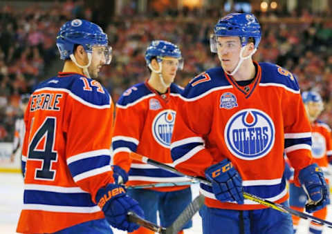 NHL Alternate Jerseys: Edmonton Oilers forward Jordan Eberle (14) and forward Connor McDavid (97) discuss a plan prior to a face-off against the Vancouver Canucks at Rexall Place. Mandatory Credit: Perry Nelson-USA TODAY Sports