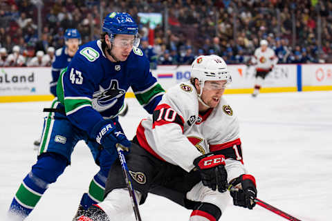 Apr 19, 2022; Vancouver, British Columbia, CAN; Vancouver Canucks defenseman Quinn Hughes (43) battles with Ottawa Senators forward Alex Formenton (10) in the second period at Rogers Arena. Mandatory Credit: Bob Frid-USA TODAY Sports