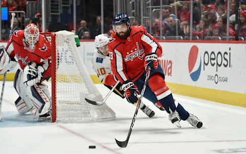 WASHINGTON, DC – NOVEMBER 03: Capitals defenseman Radko Gudas (33) skates the puck from behind his own net as goalie Ilya Samsonov (30) watches during the Calgary Flames vs. Washington Capitals on November 3, 2019 at Capital One Arena in Washington, D.C.. (Photo by Randy Litzinger/Icon Sportswire via Getty Images)