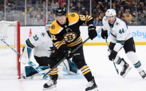 Oct 24, 2021; Boston, Massachusetts, USA; Boston Bruins center Oskar Steen (62) controls the puck in front of San Jose Sharks goaltender Adin Hill (33) while defenseman Marc-Edouard Vlasic (44) defends during the first period at TD Garden. Mandatory Credit: Bob DeChiara-USA TODAY Sports