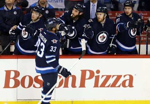 NHL Power Rankings: Winnipeg Jets defenseman Dustin Byfuglien (33) celebrates with teammates after he scores on Detroit Red Wings goalie Petr Mrazek (34) (not shown) during the first period at MTS Centre. Mandatory Credit: Bruce Fedyck-USA TODAY Sports