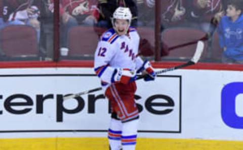 Dec 29, 2016; Glendale, AZ, USA; New York Rangers left wing Matt Puempel (12) celebrates after scoring his third goal of the game for a hat trick during the third period against the Arizona Coyotes at Gila River Arena. Mandatory Credit: Matt Kartozian-USA TODAY Sports