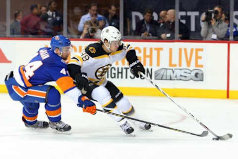 Oct 23, 2015; Brooklyn, NY, USA; Boston Bruins left wing David Pastrnak (88) controls the puck against New York Islanders defenseman Calvin de Haan (44) during the third period at Barclays Center. Mandatory Credit: Brad Penner-USA TODAY Sports