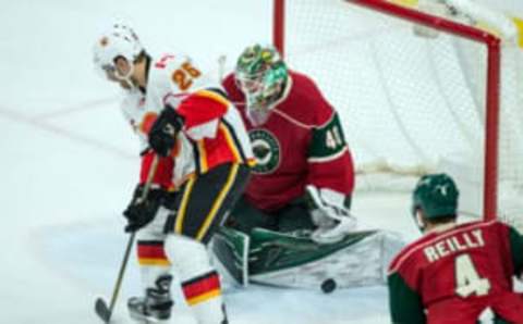 Nov 15, 2016; Saint Paul, MN, USA; Minnesota Wild goalie Devan Dubnyk (40) makes a save in front of Calgary Flames forward Freddie Hamilton (25) during the third period at Xcel Energy Center. The Flames defeated the Wild 1-0. Mandatory Credit: Brace Hemmelgarn-USA TODAY Sports