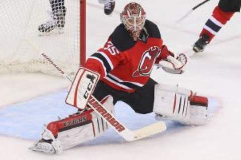 Feb 6, 2016; Newark, NJ, USA; New Jersey Devils goalie Cory Schneider (35) makes a save during overtime against the Washington Capitals at Prudential Center. The Capitals defeated the Devils 3-2 in a shootout. Mandatory Credit: Ed Mulholland-USA TODAY Sports