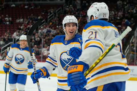 Jan 29, 2022; Glendale, Arizona, USA; Buffalo Sabres right wing Kyle Okposo (21) celebrates with center Dylan Cozens (24) after scoring against Arizona Coyotes at Gila River Arena. Mandatory Credit: Rick Scuteri-USA TODAY Sports