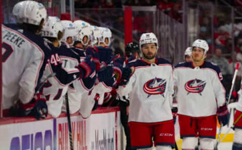 Jan 13, 2022; Raleigh, North Carolina, USA; Columbus Blue Jackets center Emil Bemstrom (52) is congratulated by the bench after scoring a goal against the Carolina Hurricanes during the first period at PNC Arena. Mandatory Credit: James Guillory-USA TODAY Sports