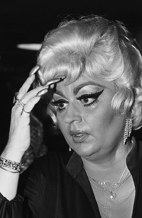 Drag queen and John Waters's muse, Divine, poses for photographers at a 1980 movie premiere.