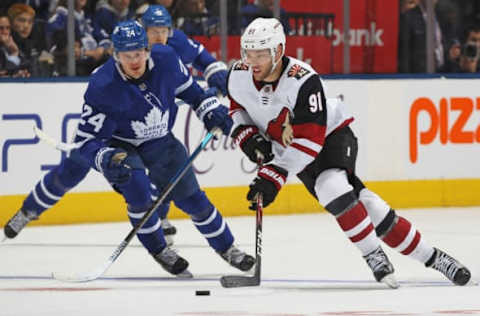 TORONTO, ON – FEBRUARY 11: Taylor Hall #91 of the Arizona Coyotes skates with the puck against Kasperi Kapanen #24 of the Toronto Maple Leafs during an NHL game at Scotiabank Arena on February 11, 2020, in Toronto, Ontario, Canada. The Maple Leafs defeated the Coyotes 3-2 in overtime. (Photo by Claus Andersen/Getty Images)