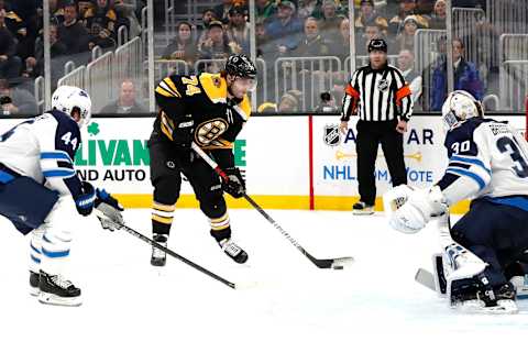 BOSTON, MA – JANUARY 09: Boston Bruins left wing Jake DeBrusk (74) shoots on Winnipeg Jets goalie Laurent Brossoit (30) during a game between the Boston Bruins and the Winnipeg Jets on January 9, 2020, at TD Garden in Boston, Massachusetts. (Photo by Fred Kfoury III/Icon Sportswire via Getty Images)