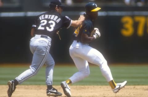 OAKLAND, CA – CIRCA 1995: Outfielder Rickey Henderson #24 of the Oakland Athletics gets tagged out by Robin Ventura #23 of the Chicago White Sox during an Major League Baseball game circa 1995 at the Oakland-Alameda County Coliseum in Oakland, California. Henderson played for the Athletics from 1979-84, 1989-93,1994-95 and 1998. (Photo by Focus on Sport/Getty Images)