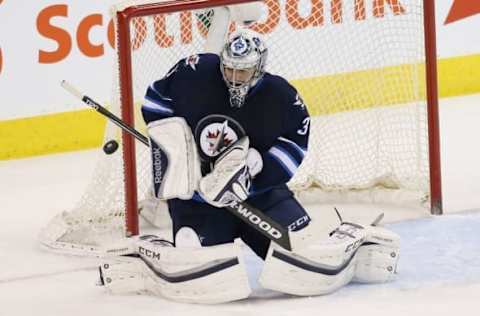 Apr 3, 2016; Winnipeg, Manitoba, CAN; Winnipeg Jets goalie Ondrej Pavelec (31) makes a save during the second period against the Minnesota Wild at MTS Centre. Mandatory Credit: Bruce Fedyck-USA TODAY Sports