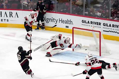 Mar 5, 2022; Glendale, Arizona, USA; Arizona Coyotes right wing Clayton Keller (9) scores a goal against Ottawa Senators goaltender Matt Murray (30) during the third period at Gila River Arena. Mandatory Credit: Joe Camporeale-USA TODAY Sports