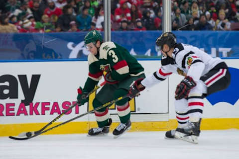 Feb 21, 2016; Minneapolis, MN, USA; Minnesota Wild forward Charlie Coyle (3) skates with the puck in the second period against the Chicago Blackhawks defenseman Viktor Svedberg (43) during a Stadium Series hockey game at TCF Bank Stadium. Mandatory Credit: Brace Hemmelgarn-USA TODAY Sports