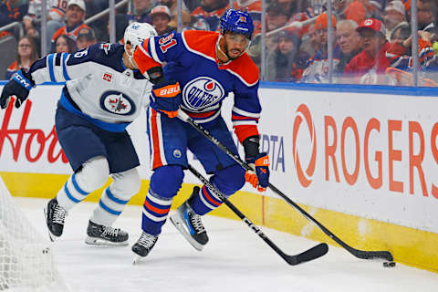 Oct 21, 2023; Edmonton, Alberta, CAN; Edmonton Oilers forward Evander Kane (91) and Winnipeg Jets forward Rasmus Kupari (15) battle for a loose puck during the first period at Rogers Place. Mandatory Credit: Perry Nelson-USA TODAY Sports