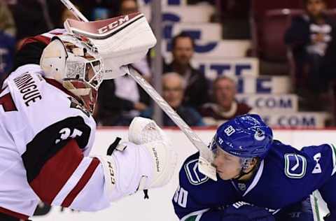 Oct 3, 2016; Vancouver, British Columbia, CAN; Vancouver Canucks forward Markus Granlund (60) is hit by Arizona Coyotes goaltender Louis Domingue (35) stick during a preseason hockey game at Rogers Arena. Mandatory Credit: Anne-Marie Sorvin-USA TODAY Sports