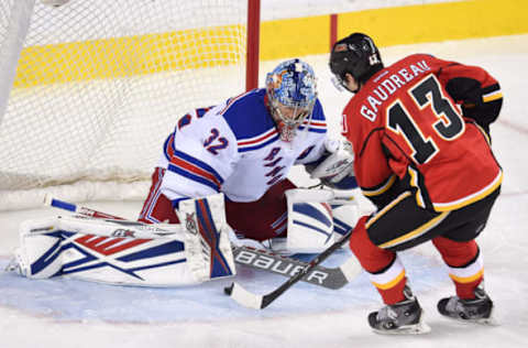 Dec 12, 2015; Calgary, Alberta, CAN; Calgary Flames left wing Johnny Gaudreau (13) scores on New York Rangers goalie Antti Raanta (32) at Scotiabank Saddledome. Flames won 5-4 in overtime. Mandatory Credit: Candice Ward-USA TODAY Sports