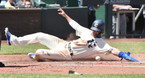 KANSAS CITY, MO – MAY 6: Whit Merrifield #15 of the Kansas City Royals slides across home to score on a Mike Moustakas sacrifice fly in the first inning against the Detroit Tigers at Kauffman Stadium on May 6, 2018, in Kansas City, Missouri. (Photo by Ed Zurga/Getty Images)