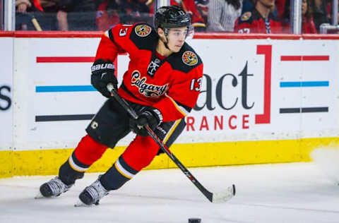 Apr 7, 2016; Calgary, Alberta, CAN; Calgary Flames left wing Johnny Gaudreau (13) skates with the puck against the Vancouver Canucks during the second period at Scotiabank Saddledome. Calgary Flames won 7-3. Mandatory Credit: Sergei Belski-USA TODAY Sports