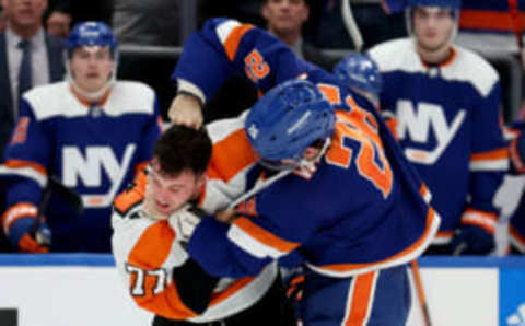 Nov 26, 2022; Elmont, New York, USA; Philadelphia Flyers defenseman Tony DeAngelo (77) fights New York Islanders right wing Oliver Wahlstrom (26) during the third period at UBS Arena. Mandatory Credit: Brad Penner-USA TODAY Sports