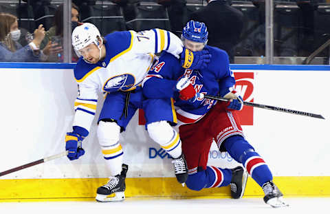 NEW YORK, NEW YORK – APRIL 27: Chris Kreider #20 of the New York Rangers checks Jacob Bryson #78 of the Buffalo Sabres into the boards during the third period at Madison Square Garden on April 27, 2021 in New York City. (Photo by Bruce Bennett/Getty Images)