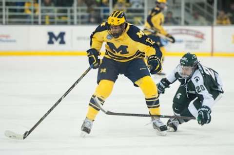 Wolverines center Cristoval Nieves sakes the puck down the ice against Spartans center Michael Ferrantino during the first period of their game at Yost Ice Arena Friday Feb. 1st.Courtney Sacco I AnnArbor.com