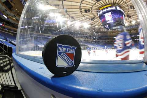 A New York Rangers puck is photographed posed on the boards prior to the game between the New York Rangers and the New York Islanders (Photo by Bruce Bennett/Getty Images)